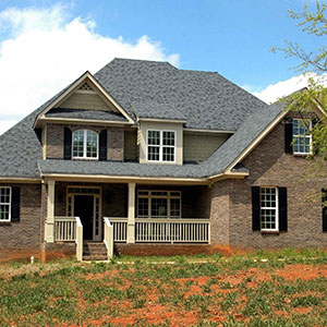 Front view of a home with a gray shingle roof